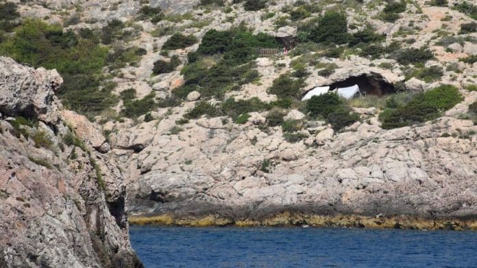 Makeshift dwellings under the wall in Ibiza Makeshift dwellings under the wall in Ibiza