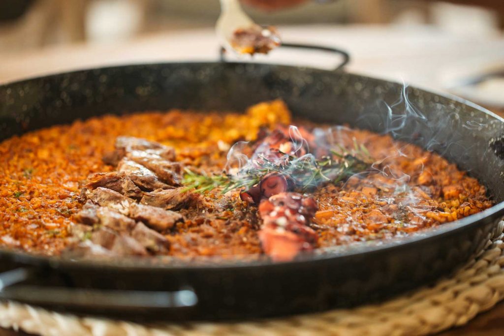 The Uhla Menu Includes A Selection Of Paellas And Salads.