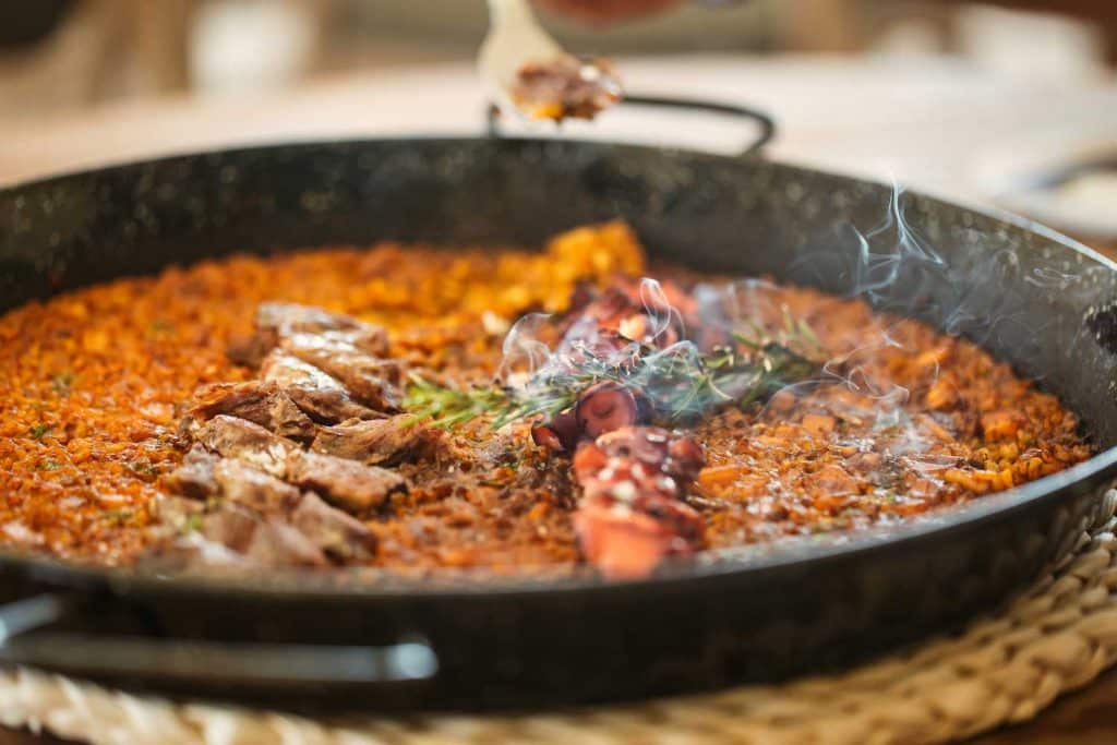 The Uhla menu includes a selection of paellas and salads.