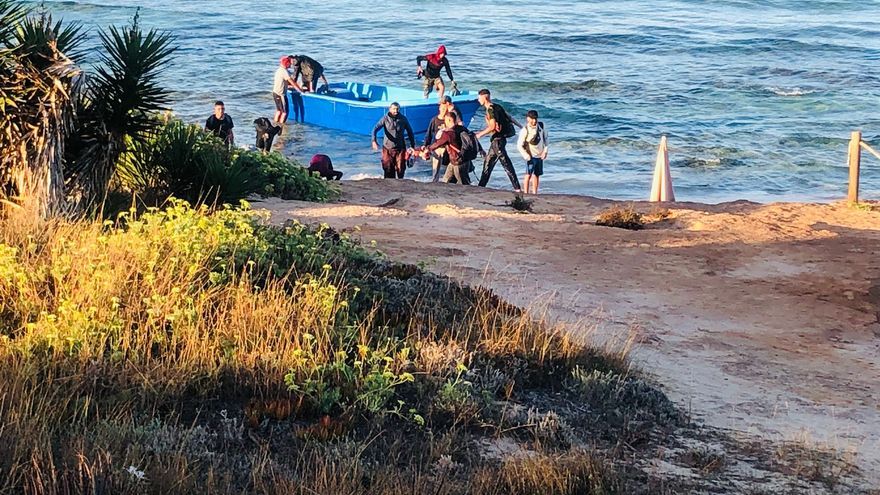 Migration on Ibiza: a boat arrives on the beach of es Copinar on Formentera