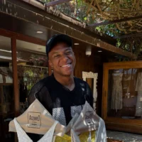 Mbappé poses smiling with several women's garments hanging on hangers. | Instagram