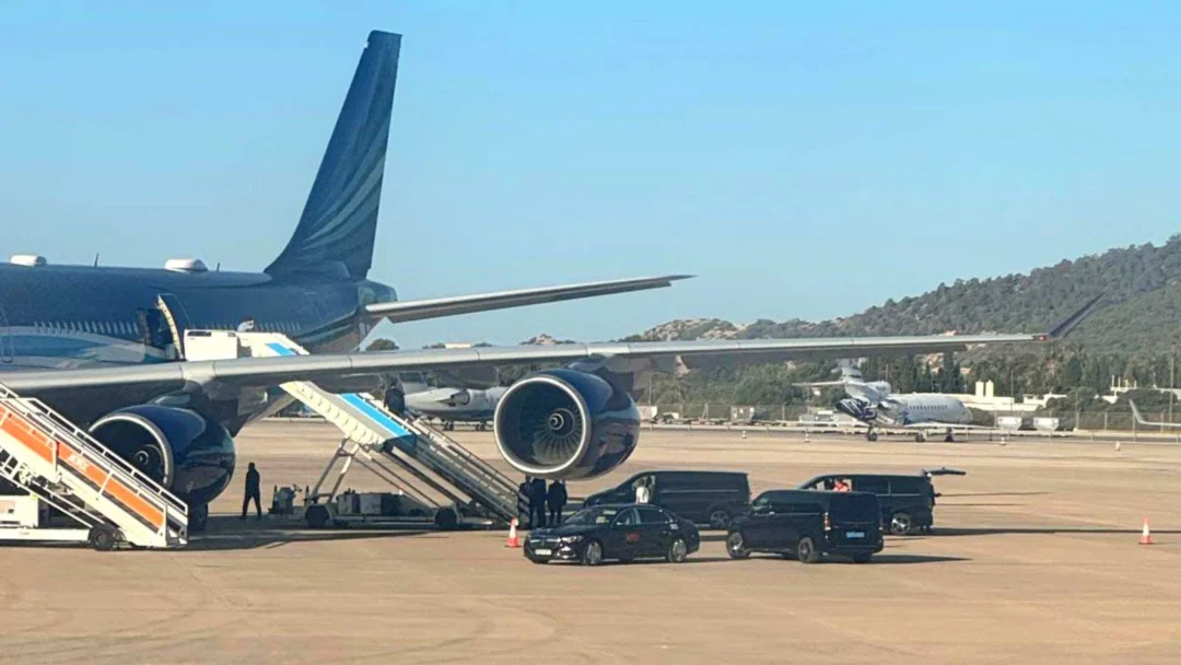 Black vans with tinted windows next to the plane. | D.I.